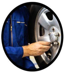 An automobile mechanic rotating a set of tires