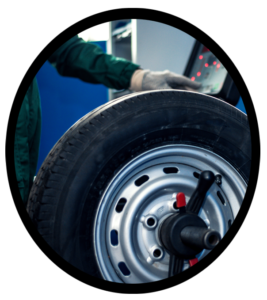 An automobile mechanic mounting a new tire on a tire rim