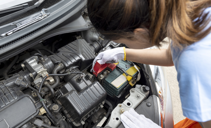 An automobile mechanic inspecting an engine