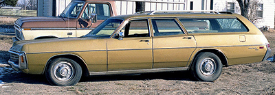 A Dodge station wagon next to a pickup truck