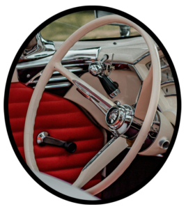 The steering wheel of an older car