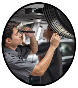 An automobile mechanic inspecting a tire