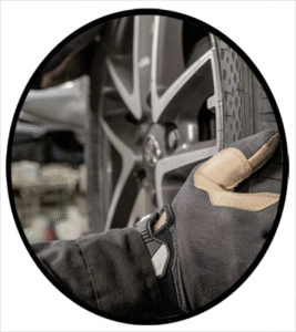 An automobile mechanic installing a new tire