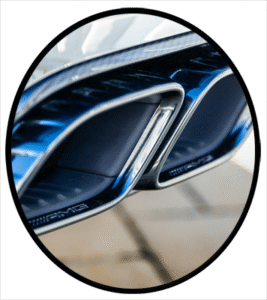 The back end of an automobile focused on the exhaust tail pipes