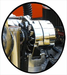 A newly rebuilt alternator installed on an antique automobile