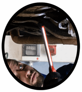 A mechanic inspecting the alignment of an automobile