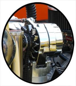 A newly rebuilt alternator installed on a vintage automobile