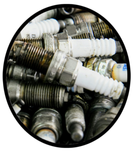 A pile of replaced automobile spark plugs