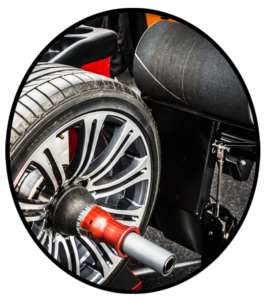 An automobile tire on a dynamic wheel balancing machine