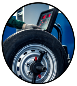 An automobile tire on a wheel balancing machine