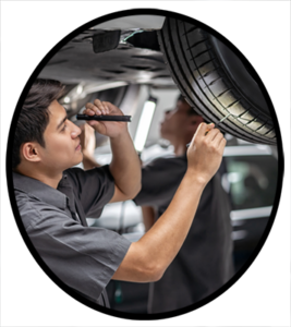 An automobile mechanic inspecting a tire for balance