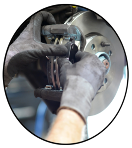 A mechanic replacing the brake pads of an automobile