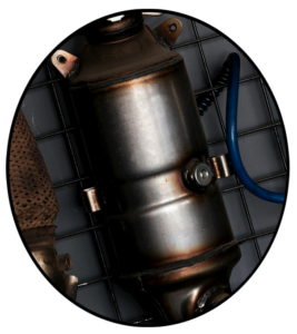 A new automotive catalytic converter hanging on a wall rack