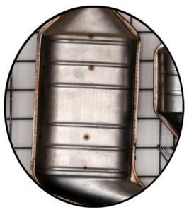 A new automotive muffler hanging on a wall rack