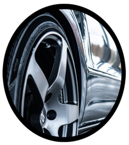 The front left side of a new car showing the tire and rim